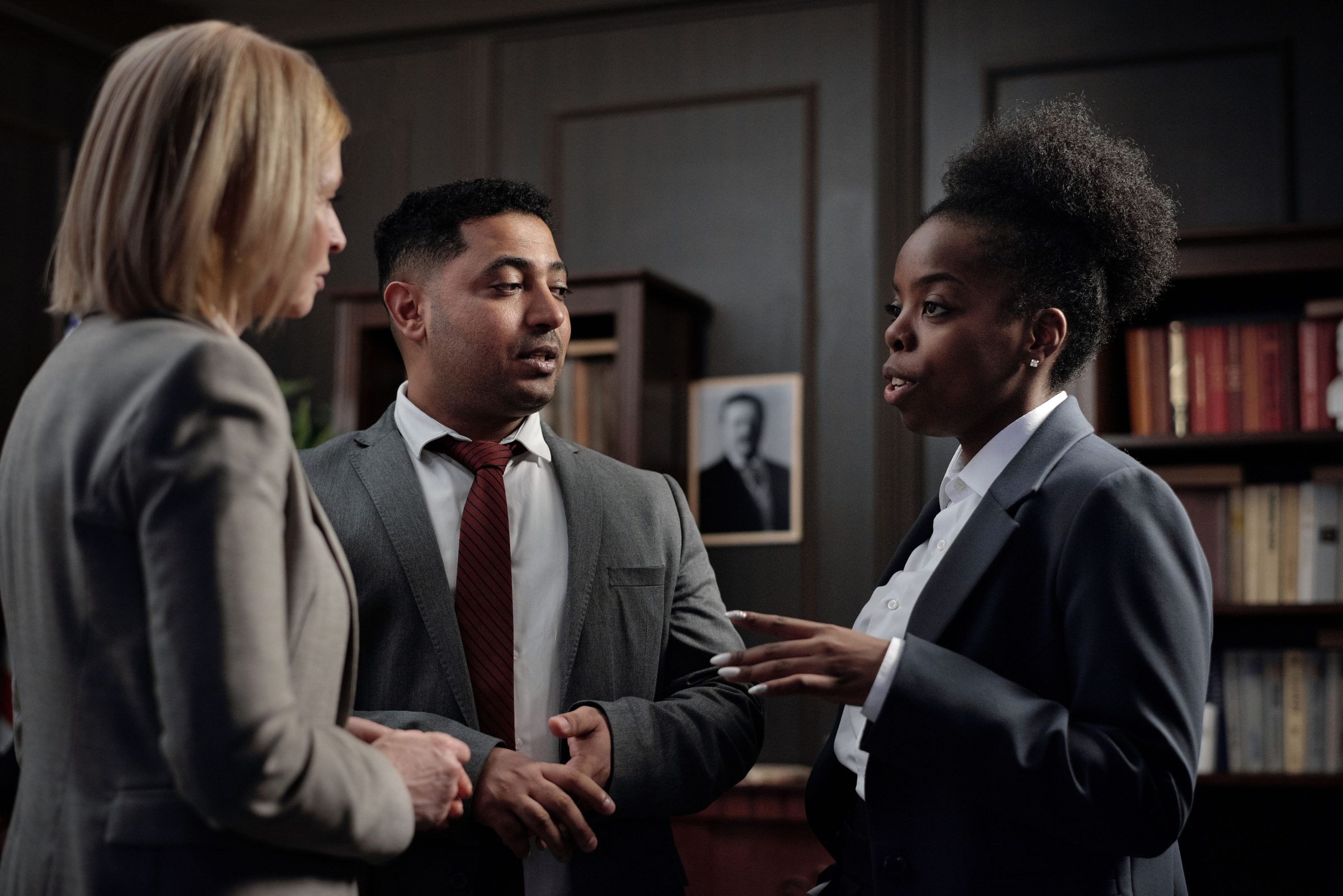 Three people talking in an office.